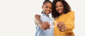 Two girls together holding a Dapivirine ring