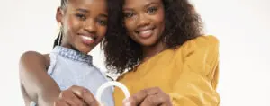 Two girls together holding a Dapivirine ring