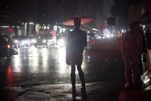 someone under an umbrella at night in a street