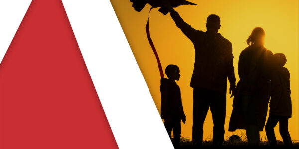 Silhouette of a family flying a kite against an orange sunset, with red and white geometric shapes on the left.