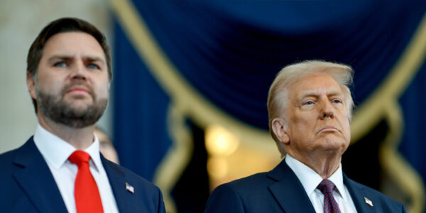 Trump and Vance stand side by side in front of a blue and gold backdrop