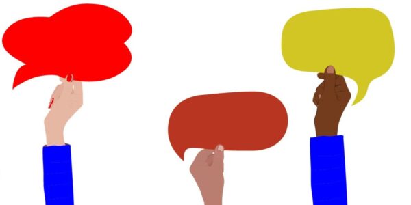 Three hands, each holding a different colored speech bubble—red, brown, and yellow - against a white background.