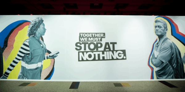 A mural displays two people facing each other with the text: 