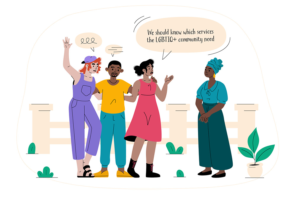 Four people stand together talking; one person is speaking and suggesting finding out which services the LGBTQIA+ community need.