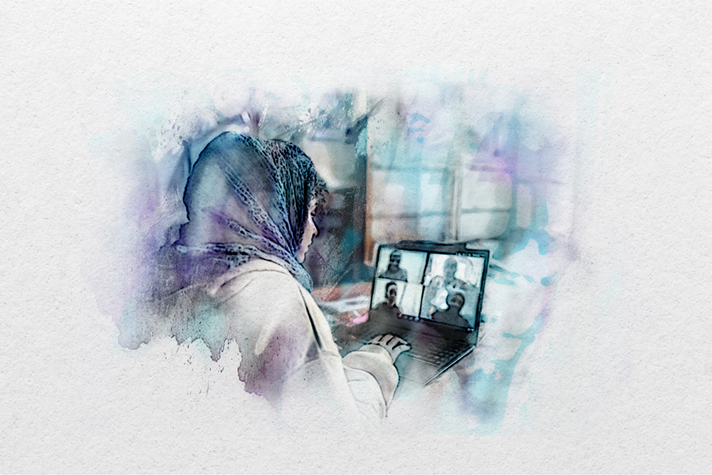A person wearing a headscarf sits at a laptop, participating in a video call with four people visible on the screen.